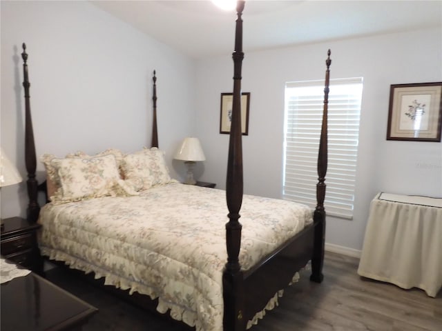 bedroom with dark wood-type flooring