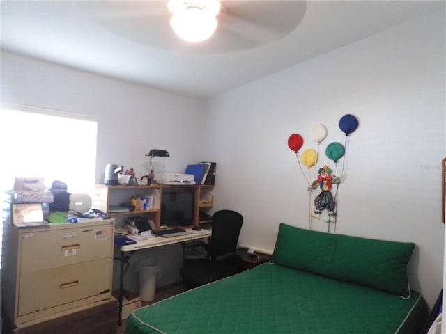 bedroom with dark hardwood / wood-style floors and ceiling fan