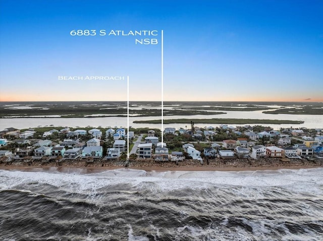 aerial view at dusk with a water view