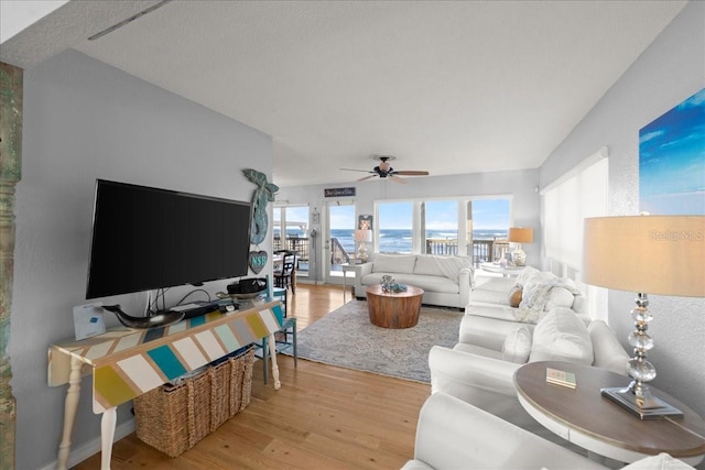 living room with light wood-type flooring and ceiling fan