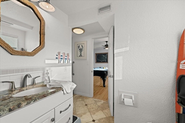 bathroom with vanity, ceiling fan, tile patterned flooring, and backsplash