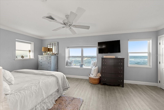 bedroom with ceiling fan, crown molding, and light wood-type flooring