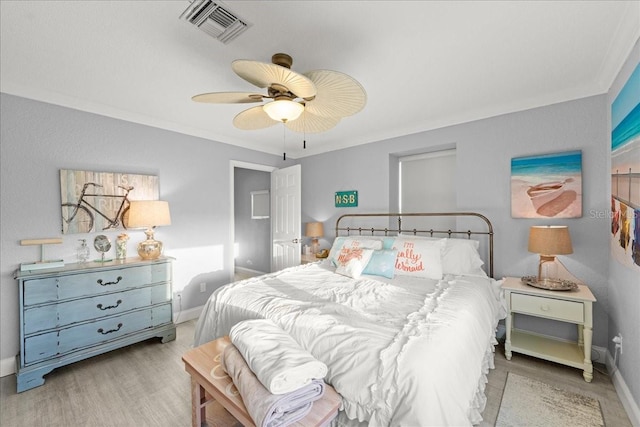 bedroom featuring ornamental molding, light hardwood / wood-style flooring, and ceiling fan