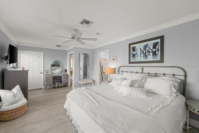 bedroom featuring light hardwood / wood-style floors, crown molding, and ceiling fan