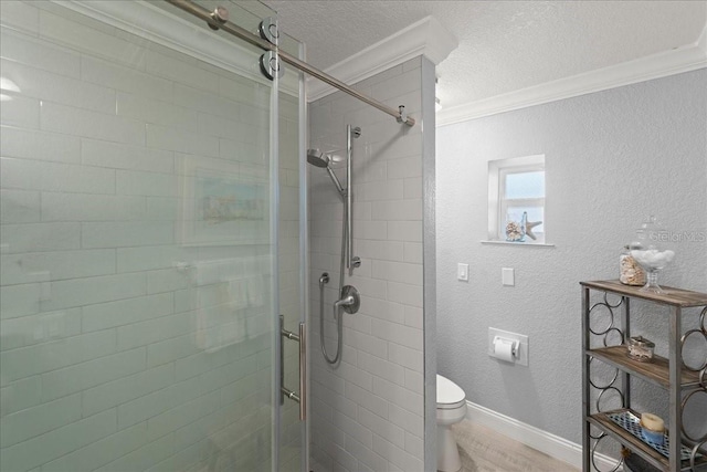 bathroom with a textured ceiling, hardwood / wood-style flooring, toilet, ornamental molding, and an enclosed shower