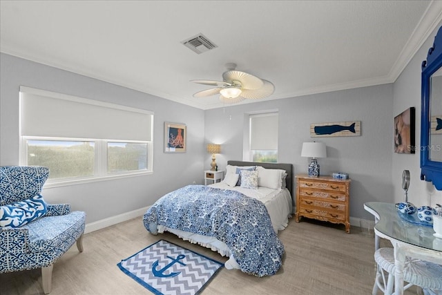 bedroom with crown molding, hardwood / wood-style floors, and ceiling fan