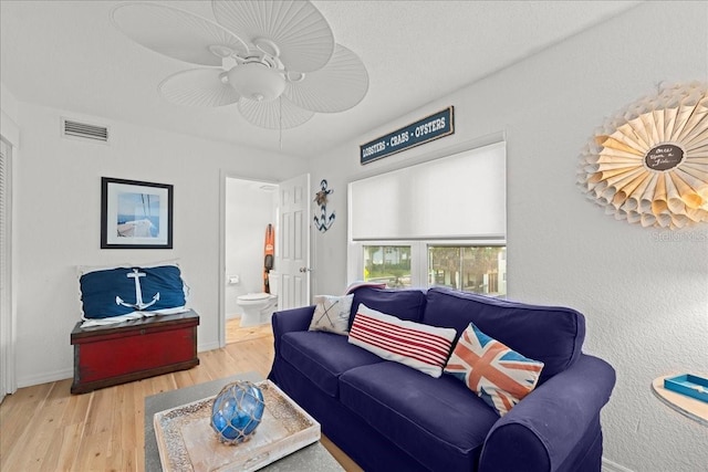 living room with ceiling fan and hardwood / wood-style floors