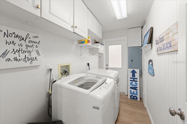 washroom featuring cabinets, washer and dryer, and light wood-type flooring