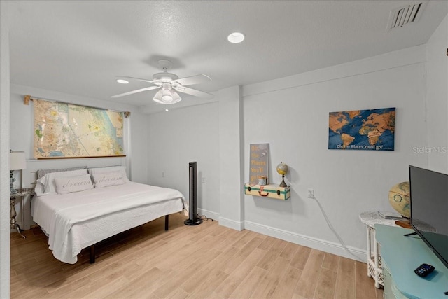 bedroom with ceiling fan and hardwood / wood-style flooring