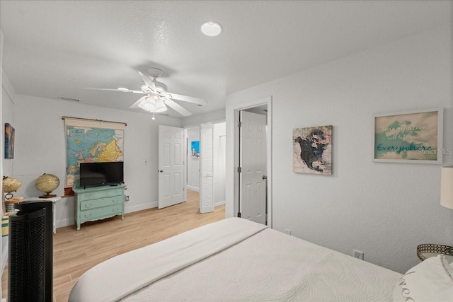 bedroom with light wood-type flooring and ceiling fan