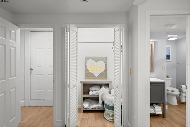 corridor with light hardwood / wood-style flooring