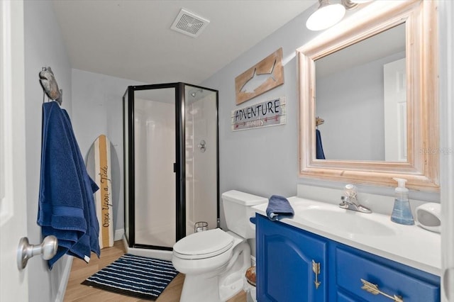 bathroom featuring vanity, toilet, walk in shower, and wood-type flooring