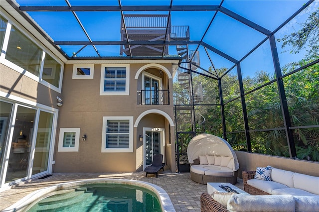 exterior space with a lanai, outdoor lounge area, and a patio