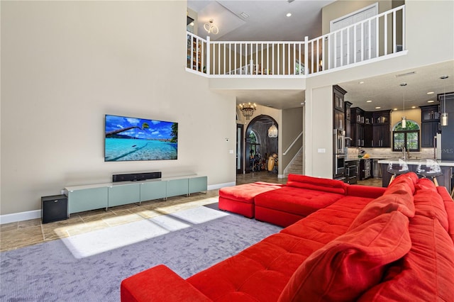 living room with sink and a high ceiling