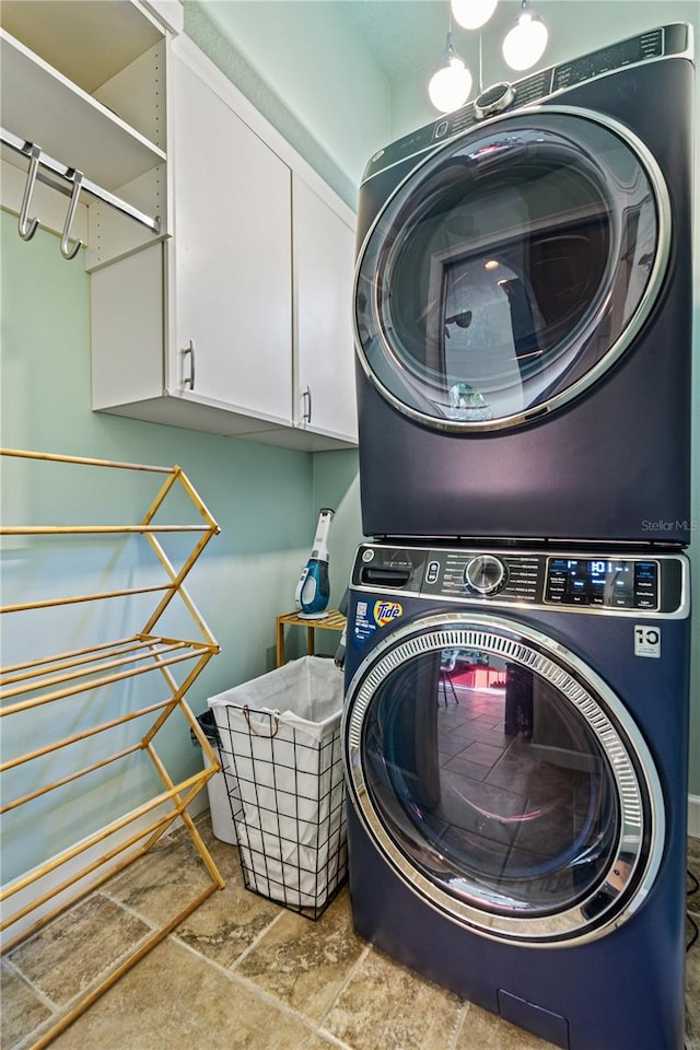 laundry area featuring stacked washer / dryer