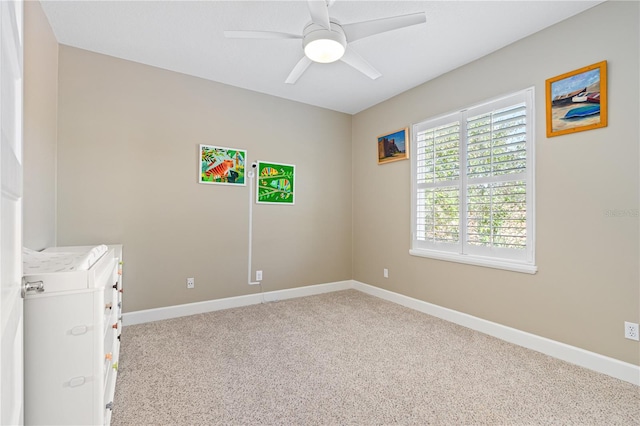 unfurnished bedroom with light colored carpet and ceiling fan