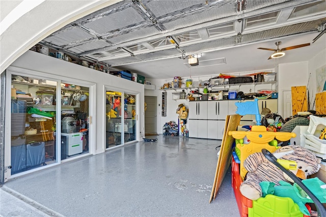 garage featuring a garage door opener and ceiling fan