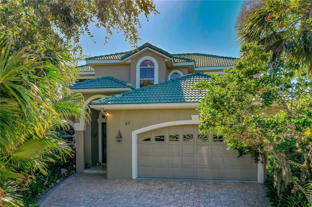 mediterranean / spanish-style home with a garage