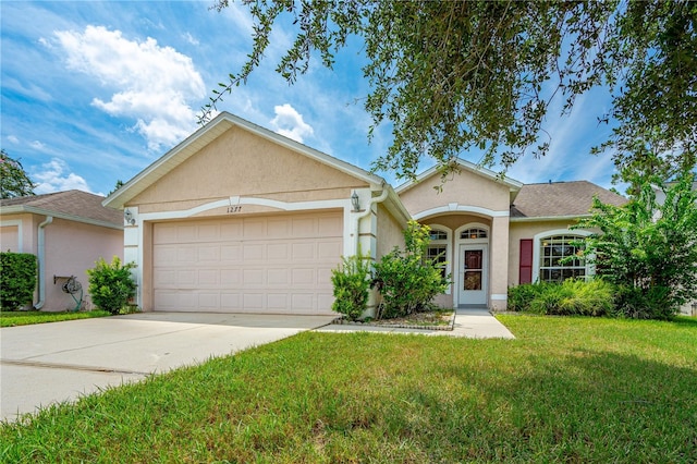 ranch-style house with a front yard and a garage