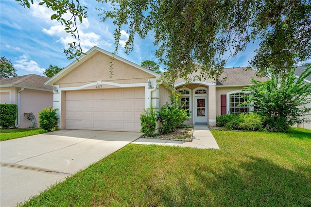 single story home featuring a front yard and a garage