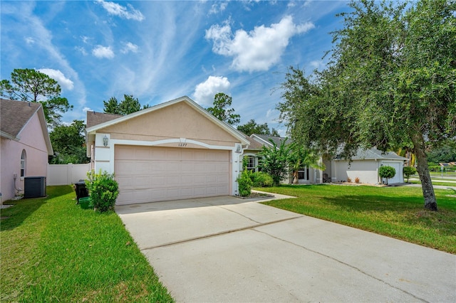 view of front of house with a front yard, cooling unit, and a garage