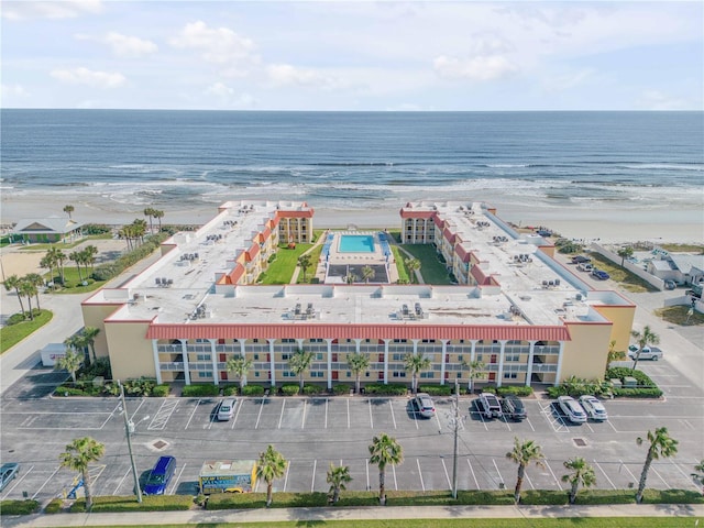 drone / aerial view with a beach view and a water view