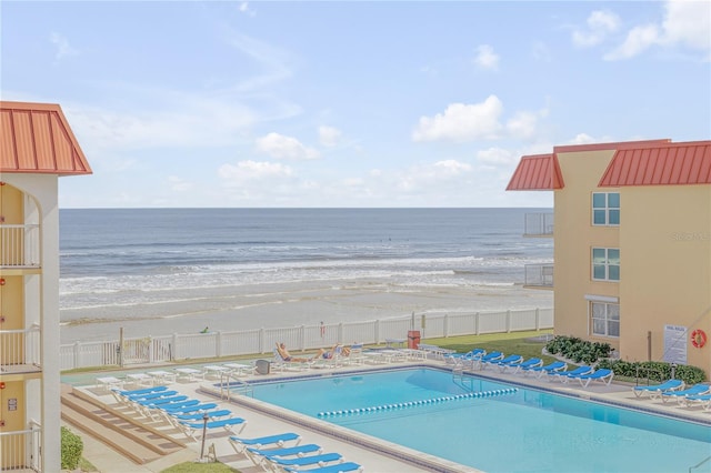 view of pool with a beach view and a water view