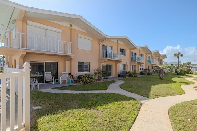 view of home's community featuring a yard and a patio