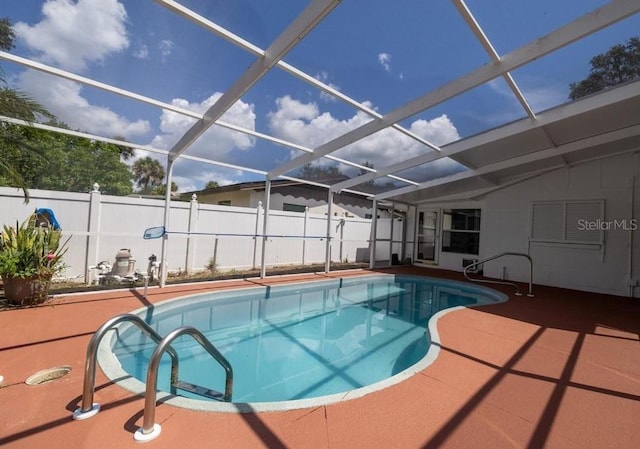 view of pool with a patio and glass enclosure