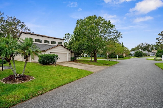 view of front of home with a front yard and a garage