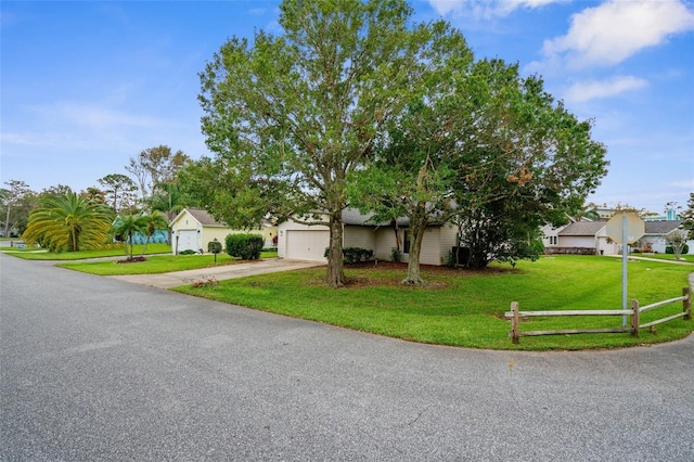 view of front facade with a front yard and a garage