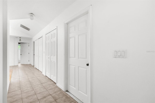 172 Gull Dr S, Daytona Beach, FL 32119 - hall featuring light tile patterned floors and lofted ceiling