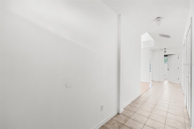 hall featuring light tile patterned floors