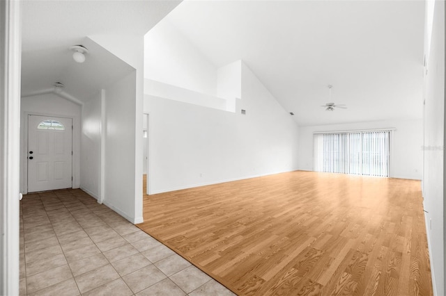 unfurnished living room with lofted ceiling, light hardwood / wood-style floors, and ceiling fan