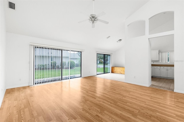 unfurnished living room featuring high vaulted ceiling, light hardwood / wood-style floors, and ceiling fan