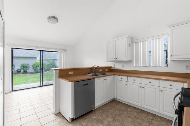 172 Gull Dr S, Daytona Beach, FL 32119 - kitchen with dishwasher, a sink, light tile patterned floors, a peninsula, and white cabinets
