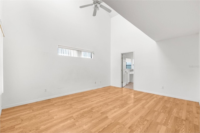 unfurnished living room featuring light hardwood / wood-style flooring, high vaulted ceiling, and ceiling fan