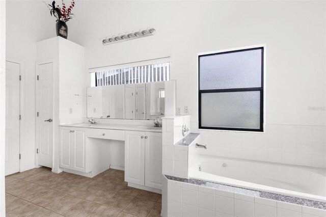 172 Gull Dr S, Daytona Beach, FL 32119 - bathroom with double vanity, a garden tub, and tile patterned floors