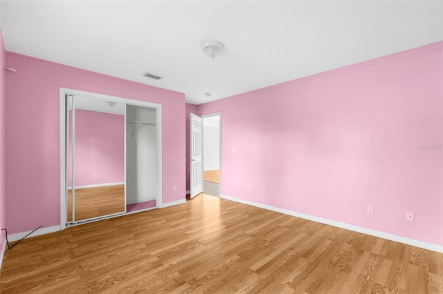 172 Gull Dr S, Daytona Beach, FL 32119 - unfurnished bedroom with light wood-type flooring, baseboards, and a closet