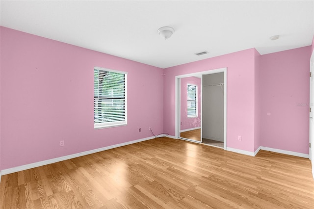 unfurnished bedroom featuring a closet and light hardwood / wood-style flooring