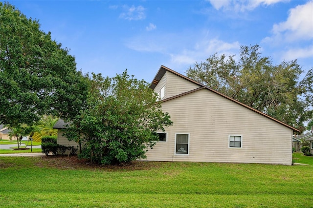 view of side of home with a lawn