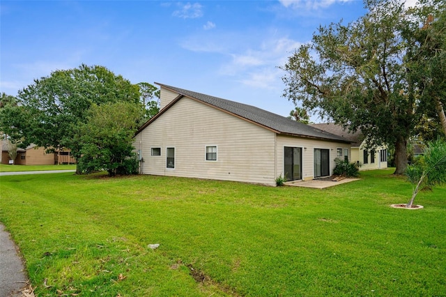 rear view of house with a lawn