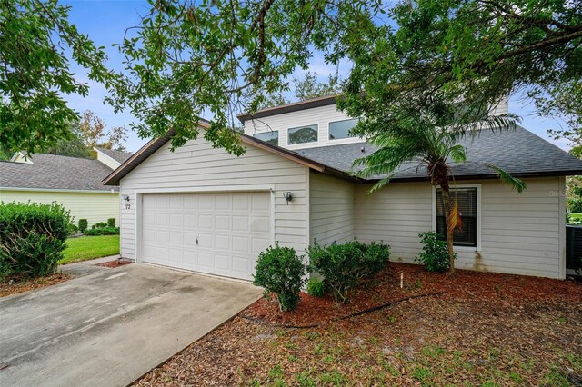 172 Gull Dr S, Daytona Beach, FL 32119 - view of front of home featuring an attached garage, roof with shingles, and driveway