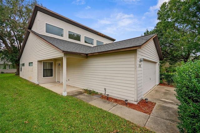 view of front of house with a front lawn and a garage