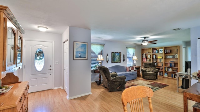 entrance foyer with ceiling fan, a wealth of natural light, and light wood-type flooring