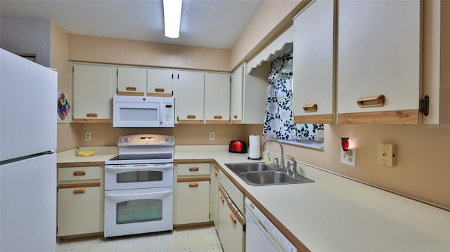 kitchen featuring white appliances, sink, and white cabinets