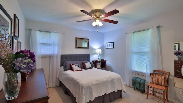 bedroom with ceiling fan and light colored carpet