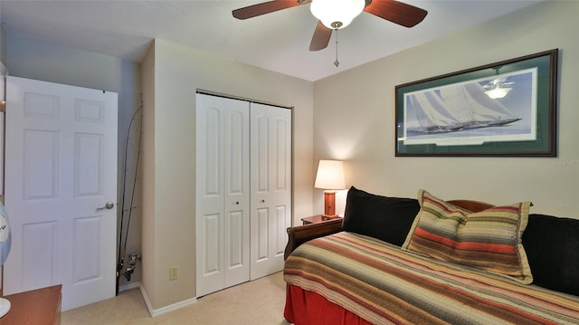 bedroom featuring light colored carpet, a closet, and ceiling fan