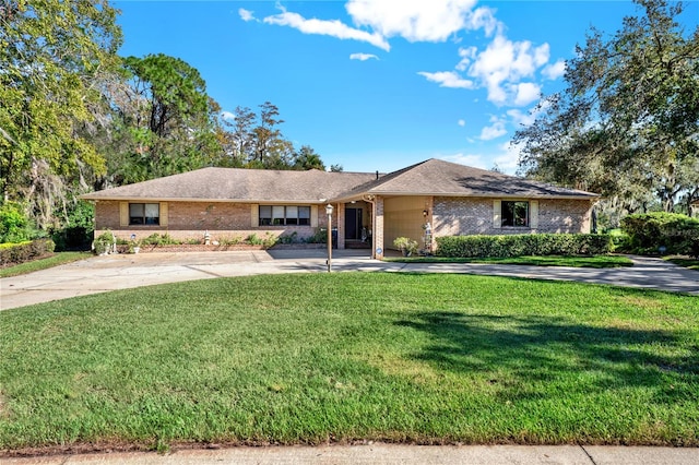 single story home featuring a front yard and a garage