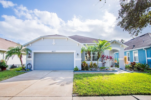 ranch-style home featuring a garage, concrete driveway, a front lawn, and stucco siding